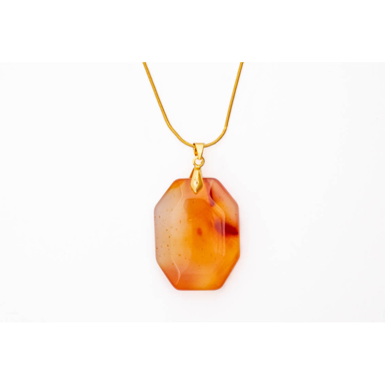 Carnelian red orange gemstone pendant on a gold coloured necklace