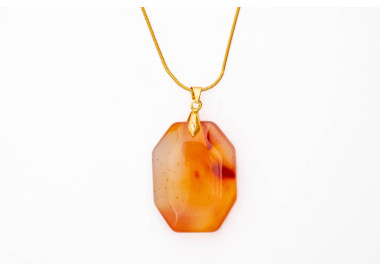 Carnelian red orange gemstone pendant on a gold coloured necklace