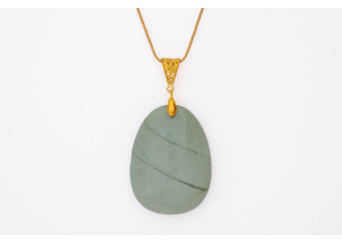 Serprentine green gemstone pendant on a silver coloured necklace