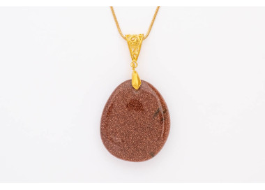 Red Sandstone gemstone pendant on a gold coloured necklace