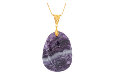 Fluorite purple gemstone pendant on a gold coloured necklace