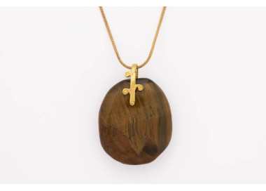 Tiger Eye gemstone pendant on a gold coloured necklace