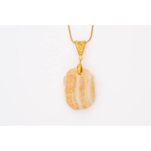 Calcite red orange gemstone pendant on a gold coloured necklace