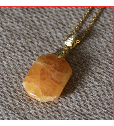 Calcite Orange Pendant on a gold coloured necklace