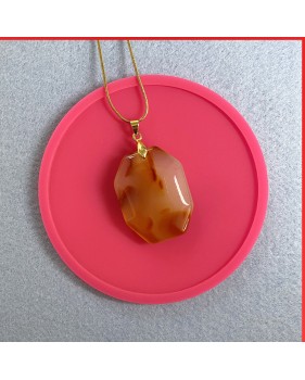 Carnelian red orange gemstone pendant on a gold coloured necklace