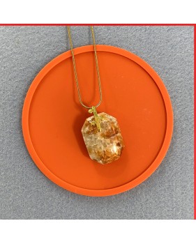 Calcite red orange gemstone pendant on a gold coloured necklace