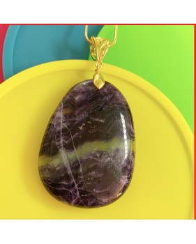 Fluorite purple gemstone pendant on a gold coloured necklace