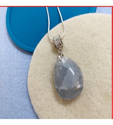 Blue aqua quartz gemstone pendant on a silver coloured necklace