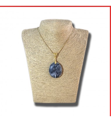 Pinolith black gemstone pendant on a gold coloured necklace