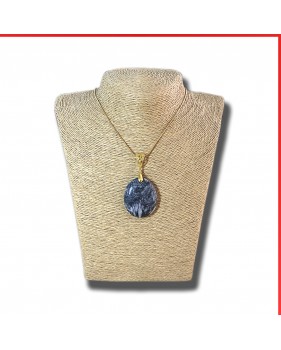 Pinolith black gemstone pendant on a gold coloured necklace
