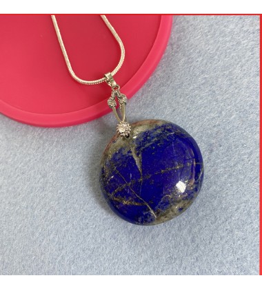 Lapis Lazuli cabouchon pendant on a silver coloured necklace