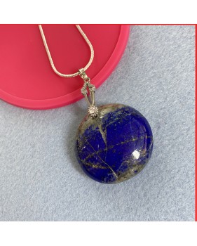 Lapis Lazuli cabouchon pendant on a silver coloured necklace