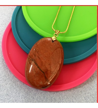 Jasper red gemstone pendant on a gold coloured necklace