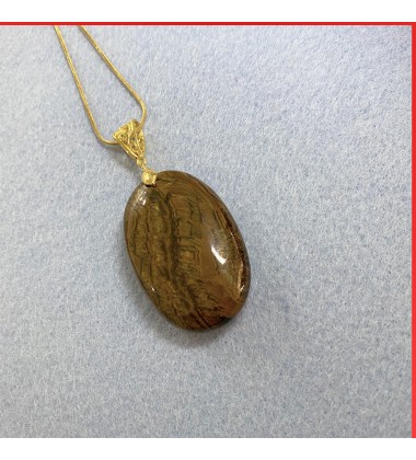 Tiger eye gemstone pendant on a gold coloured necklace