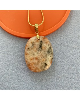Sunstone cabouchon pendant on a gold coloured necklace